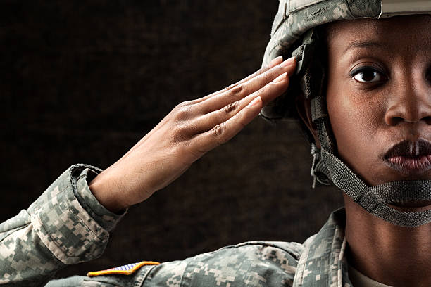 female African American in army camouflage uniform and combat helmet.